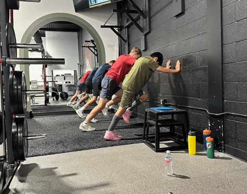 Youth athletes performing wall sprint drills during sports performance training at My State Of Fitness Gym